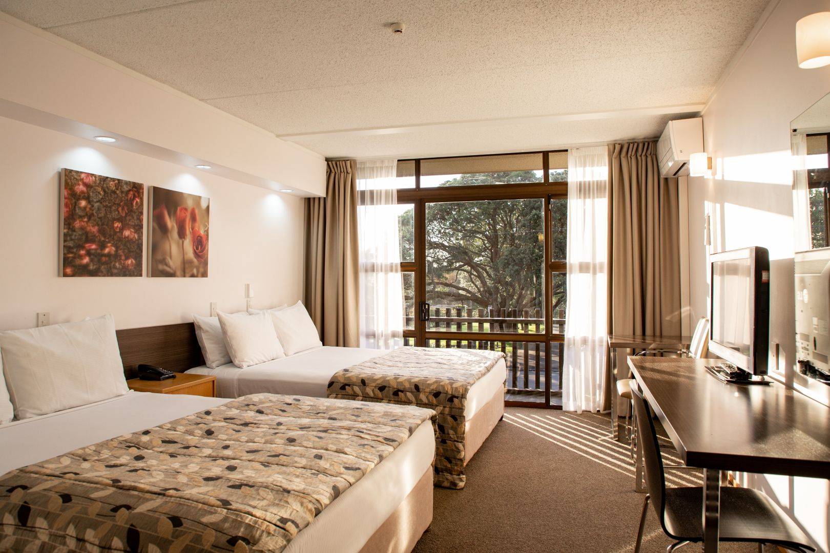 room with two double beds with a view.